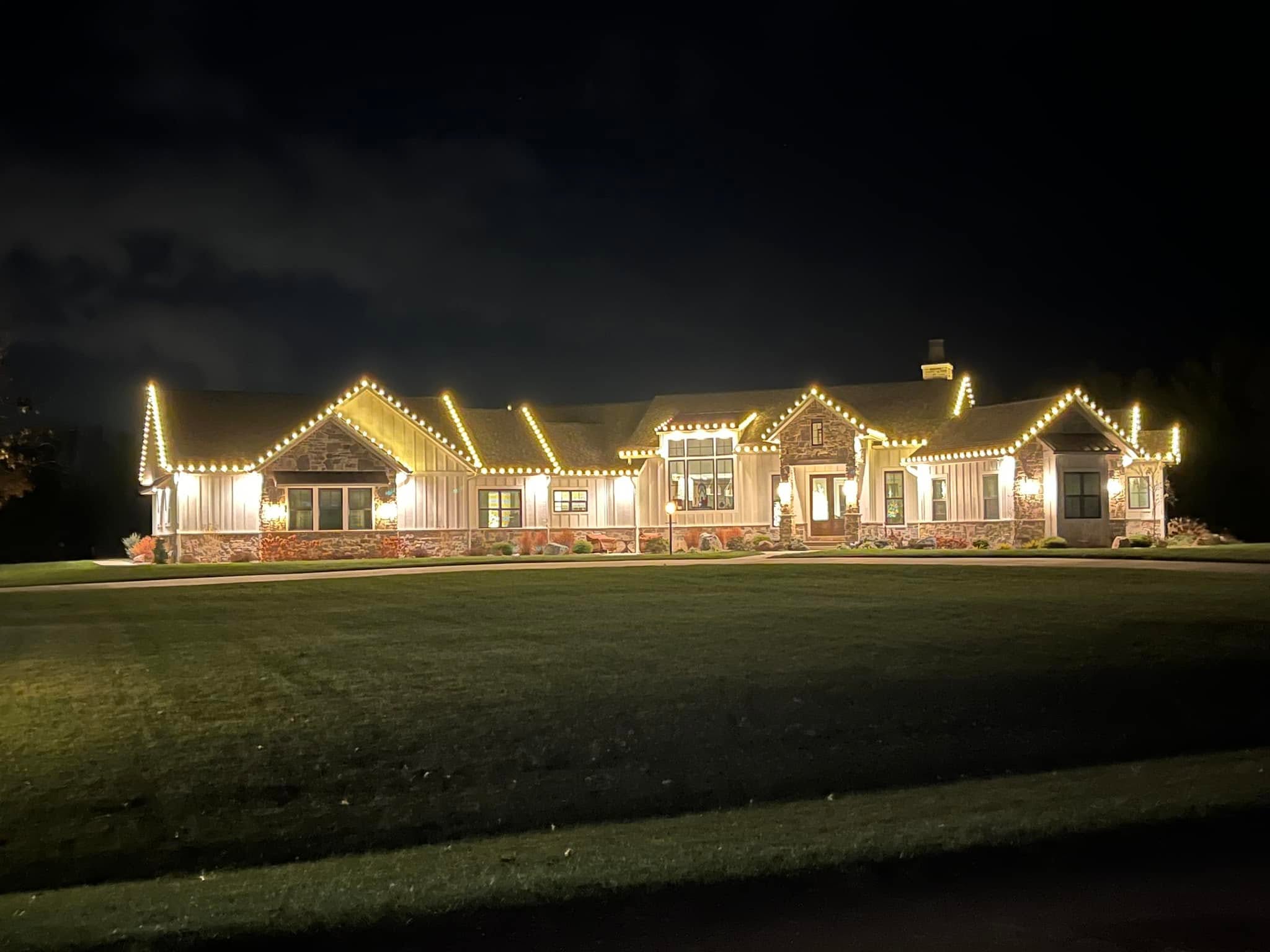 Home outlined in warm white roofline lighting