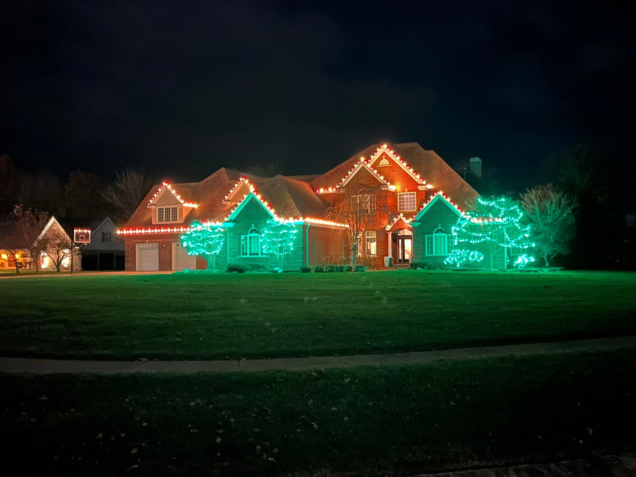 Two-storey home with lit peaks and garage