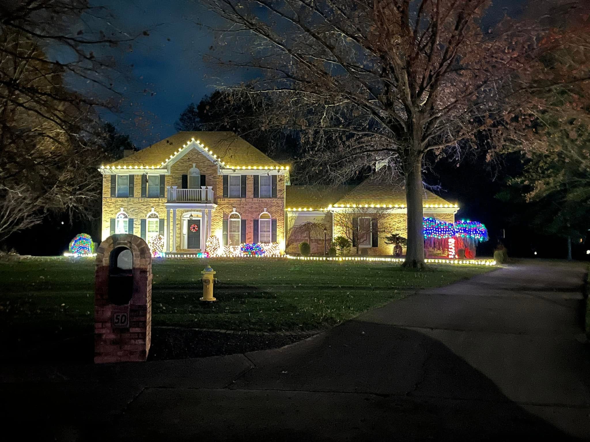 Home with red and warm white roofline and green accent lighting